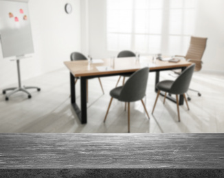 Image of Empty stone surface and blurred view of modern office interior, closeup. Space for text 