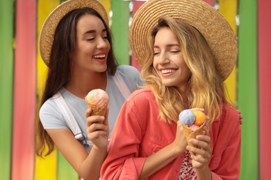 Young women with ice cream spending time together outdoors