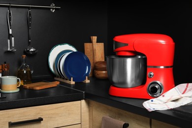 Photo of Modern red stand mixer on countertop in kitchen