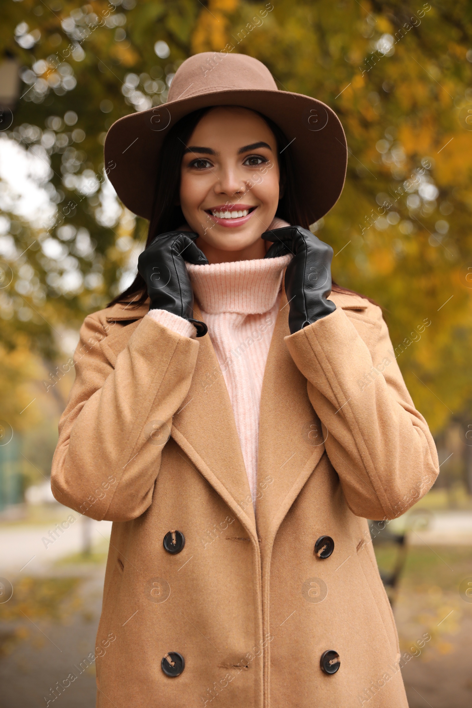 Photo of Young woman wearing stylish clothes in autumn park