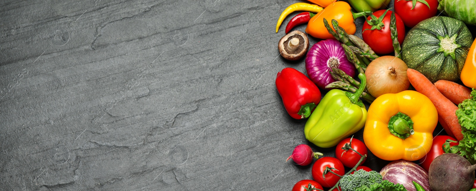 Image of Many fresh different vegetables on black table, top view with space for text. Banner design 