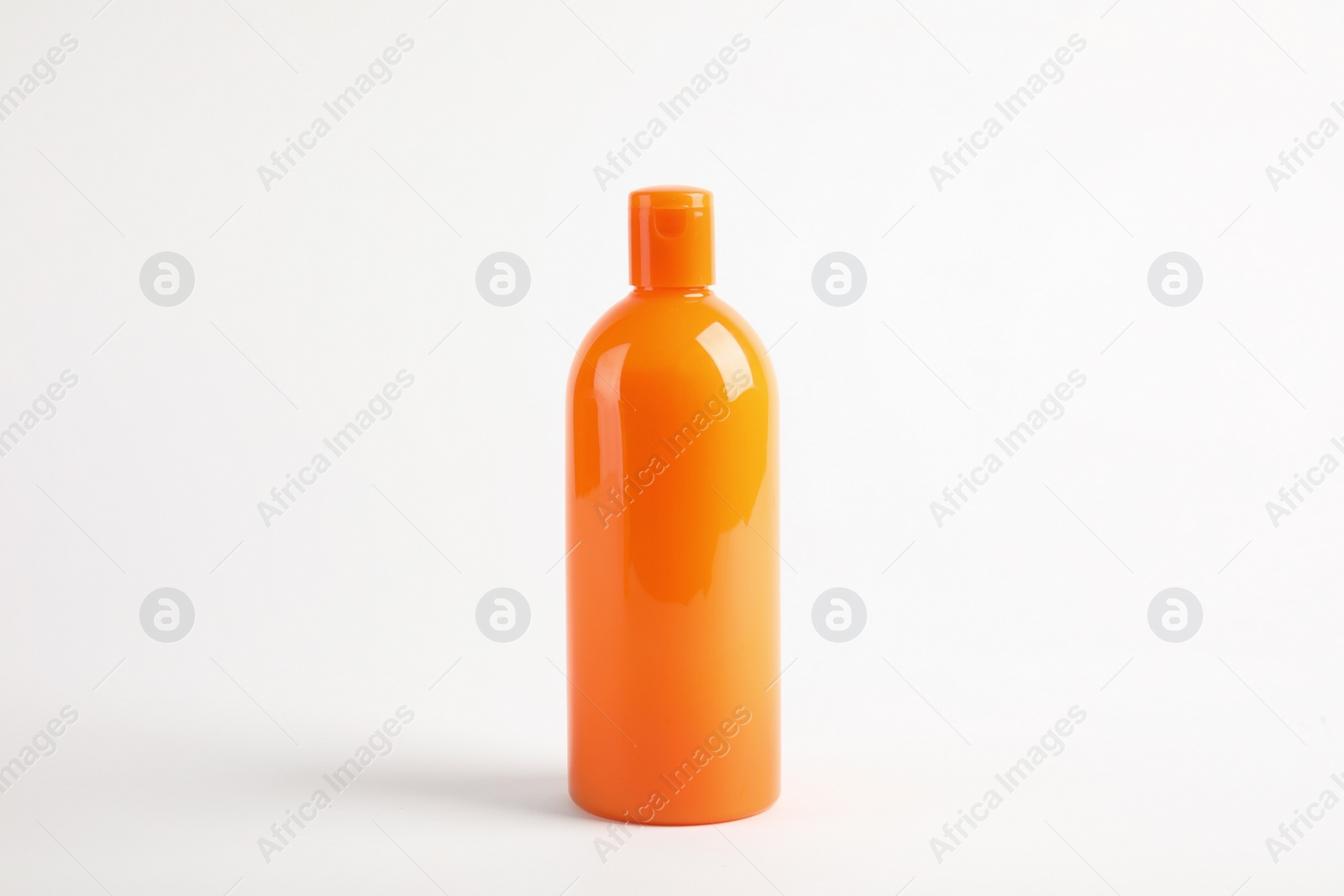 Photo of Bottle with sun protection body cream on white background