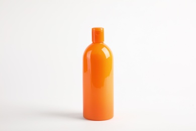 Bottle with sun protection body cream on white background