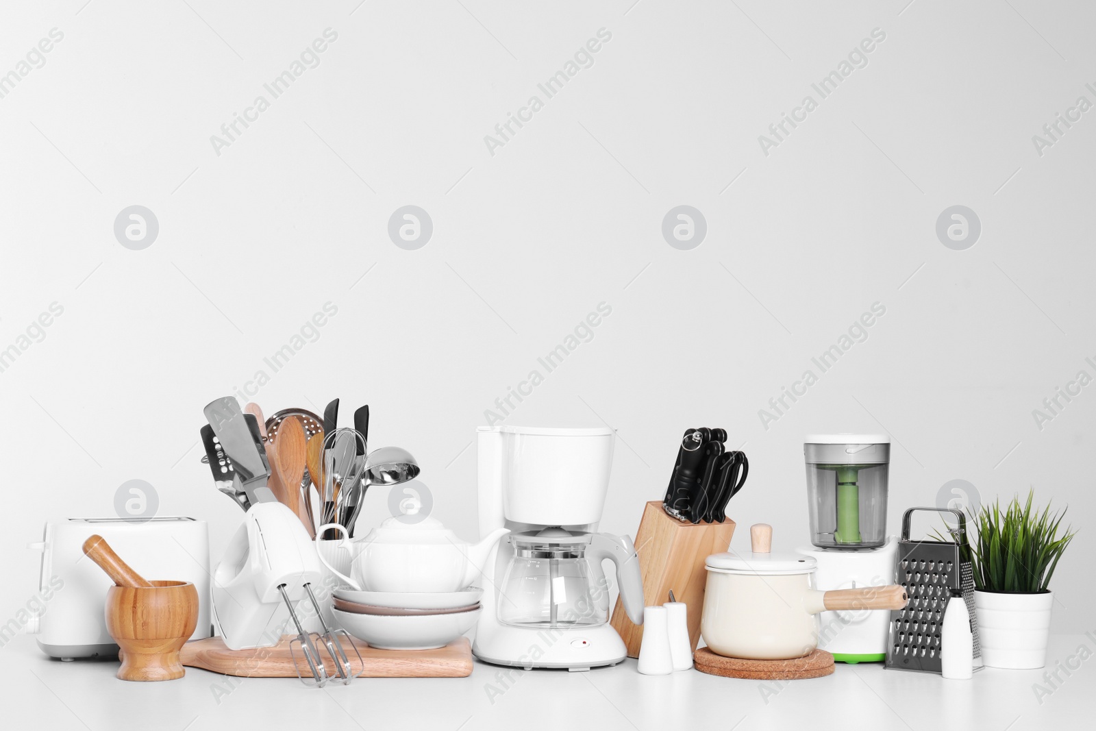 Photo of Set of clean cookware, dishes, utensils and appliances isolated on white