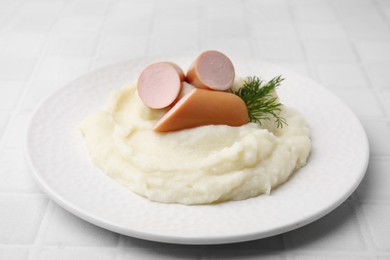 Photo of Delicious boiled sausages, mashed potato and dill on white tiled table, closeup