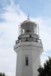 Photo of BATUMI, GEORGIA - JUNE 14, 2022: Beautiful lighthouse against cloudy sky