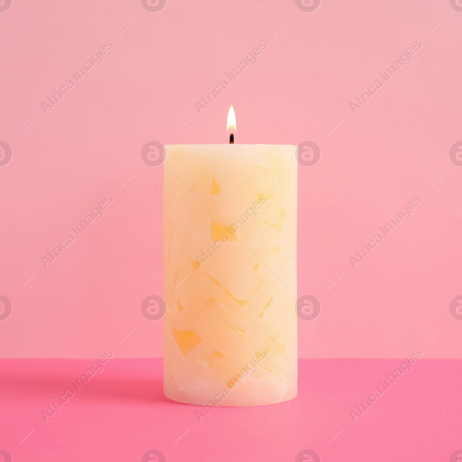 Photo of Alight scented wax candle on color background