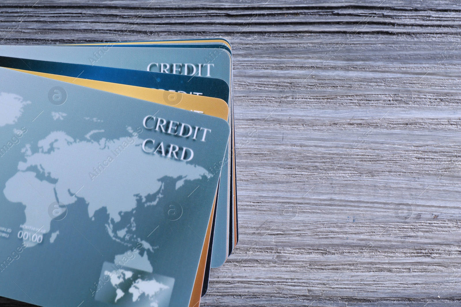 Photo of Credit cards on grey wooden table, flat lay. Space for text