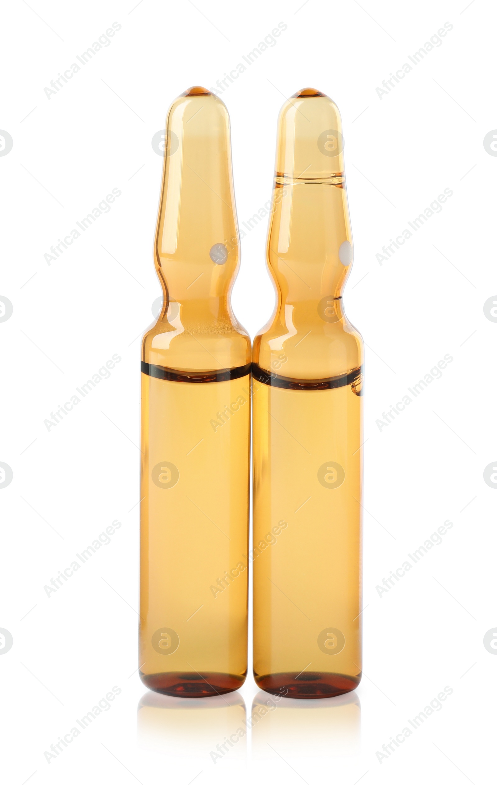 Photo of Brown pharmaceutical ampoules with medication on white background