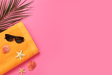 Photo of Flat lay composition with different beach objects on pink background, space for text