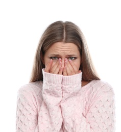 Young woman suffering from cold on white background