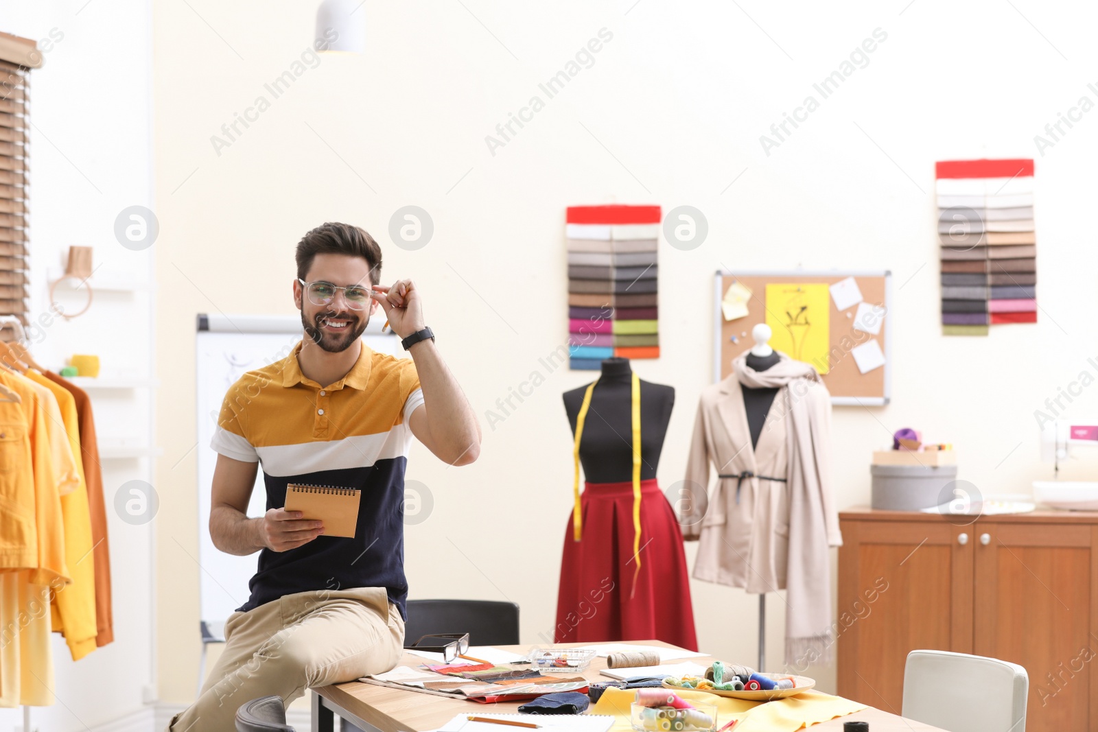 Photo of Fashion designer creating new clothes in studio