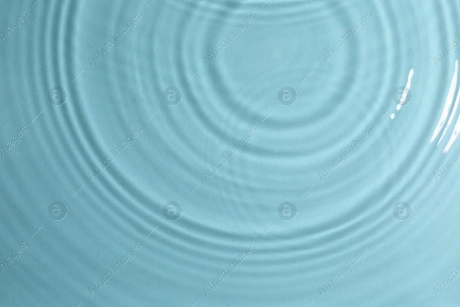 Photo of Closeup view of water with circles on turquoise background