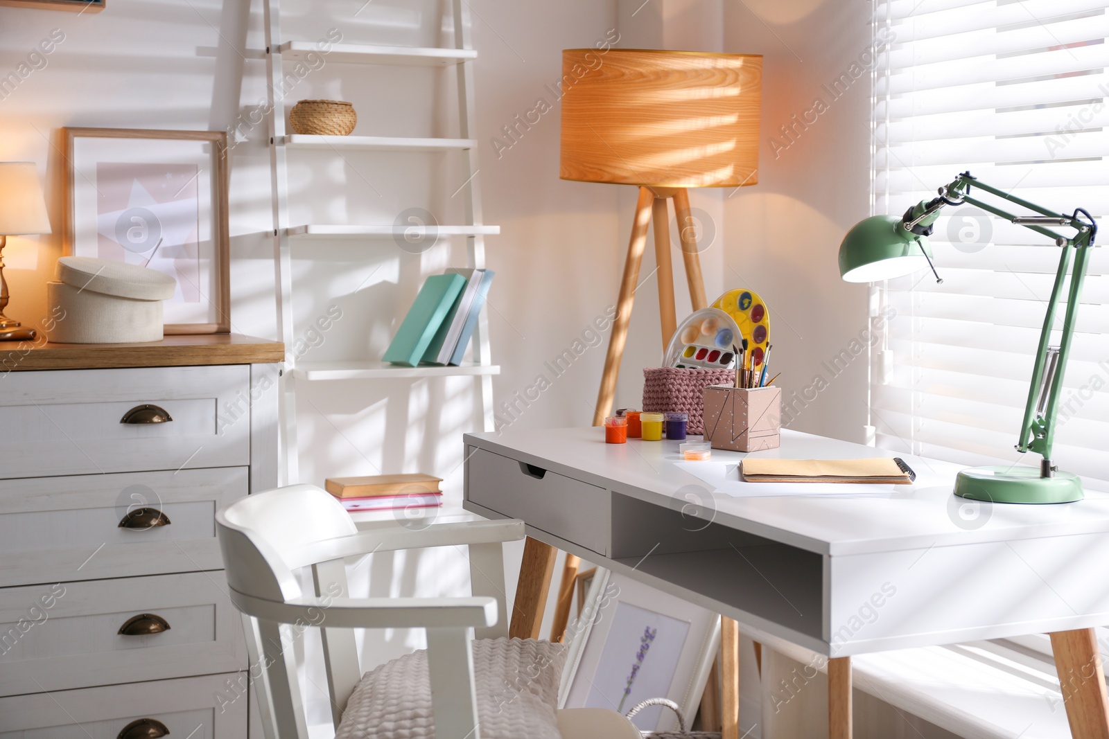 Photo of Stylish room interior with comfortable workplace near window