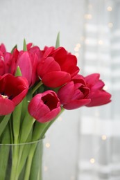 Photo of Bouquet of beautiful tulips indoors, closeup view