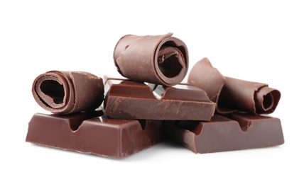 Photo of Yummy chocolate curls and pieces on white background