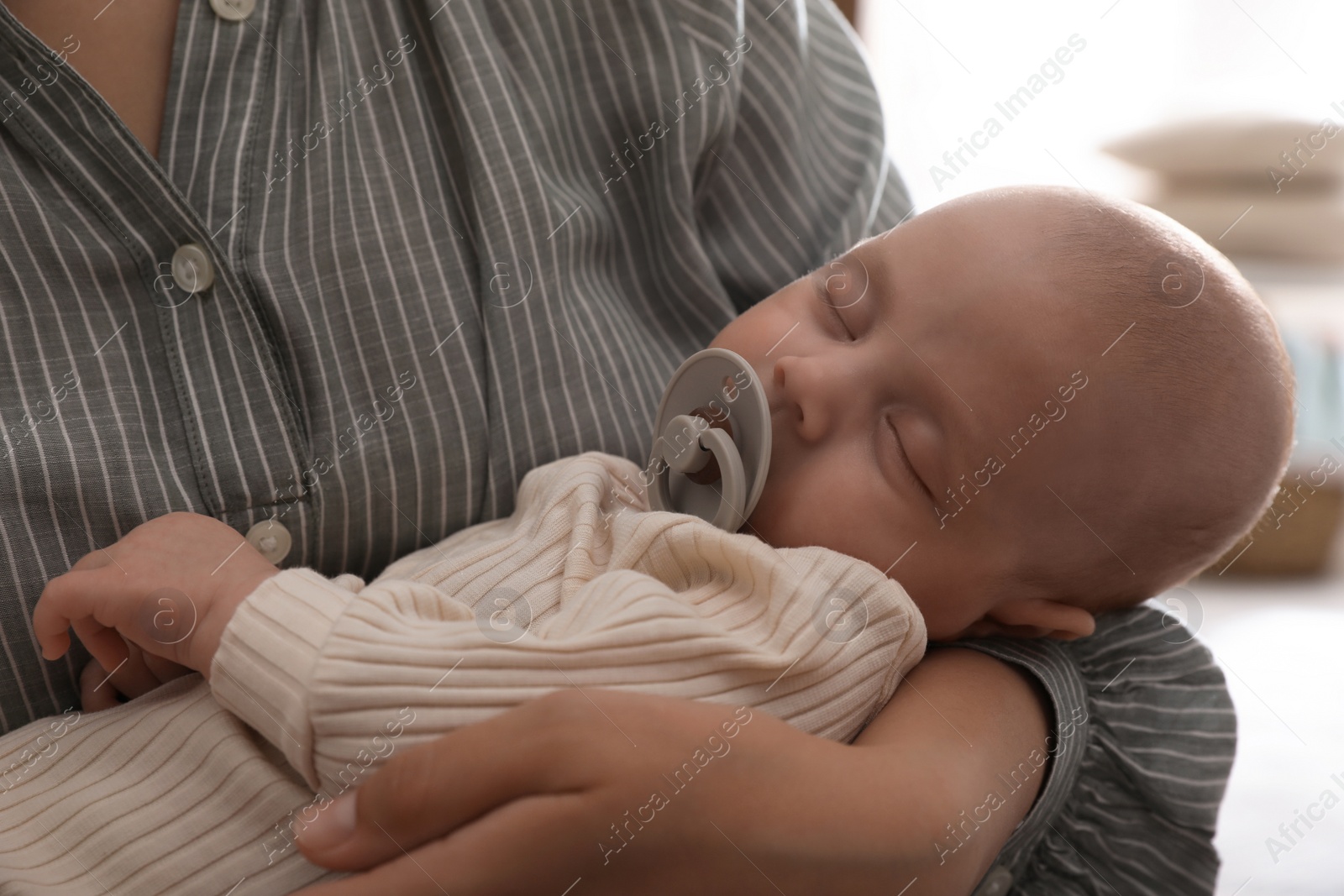 Photo of Mother with her cute sleeping baby at home, closeup