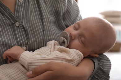 Photo of Mother with her cute sleeping baby at home, closeup