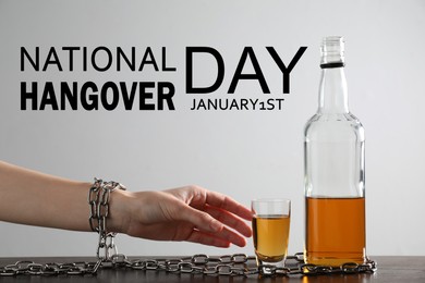 Image of National hangover day - January 1st. Woman with chains reaching for glass of alcoholic drink, closeup
