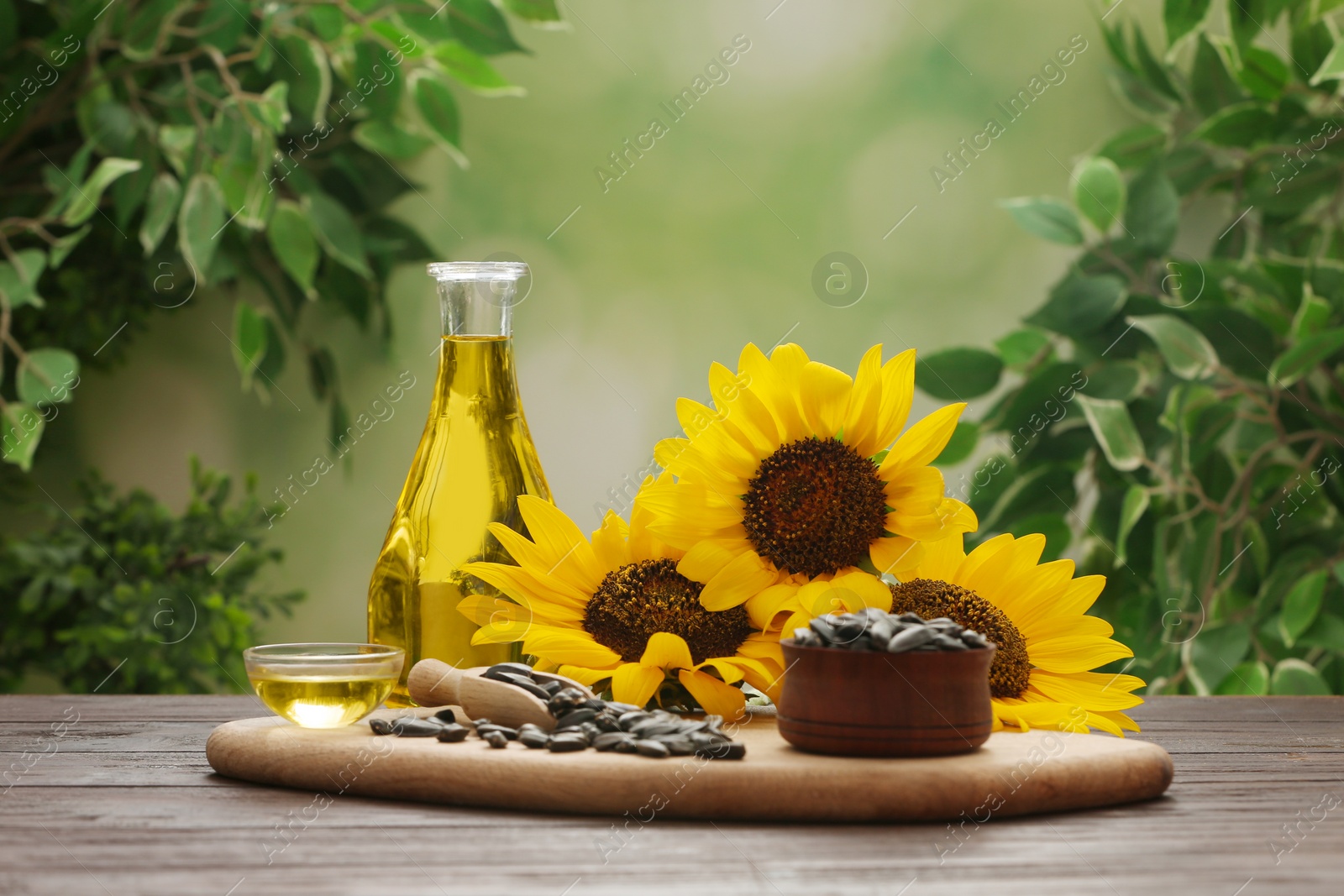 Photo of Composition with sunflower oil on wooden table against blurred background