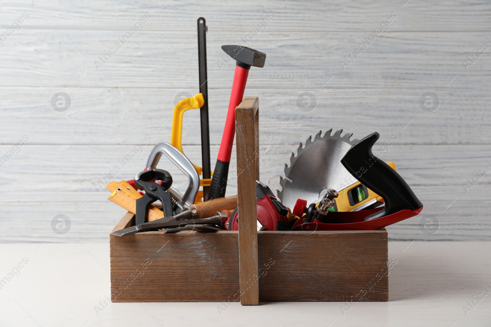 Photo of Box with carpenter's tools on white table