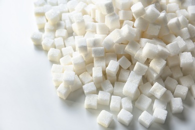 Refined sugar cubes on light background