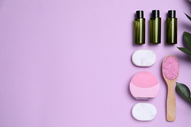 Photo of Flat lay composition with cosmetic products on violet background. Space for text