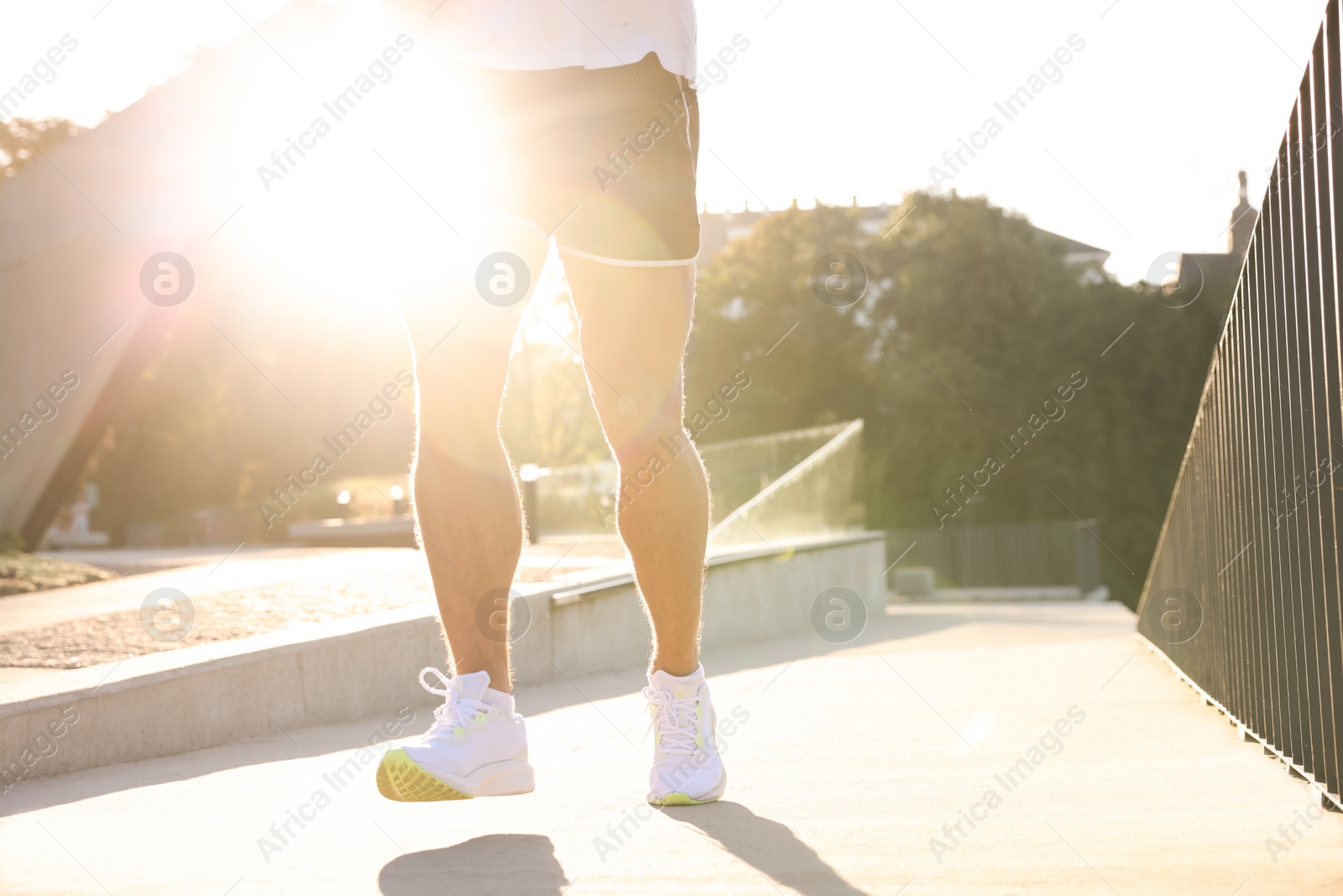 Photo of Man running outdoors on sunny day, closeup. Space for text