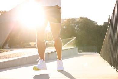 Photo of Man running outdoors on sunny day, closeup. Space for text