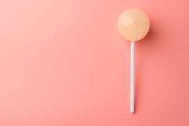 Tasty lollipop on pink background, top view. Space for text