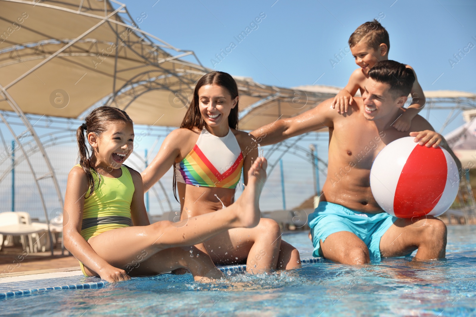 Photo of Happy family having fun at water park. Summer vacation