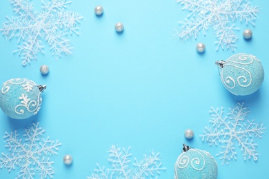 Photo of Flat lay composition with Christmas decor on blue background. Space for text