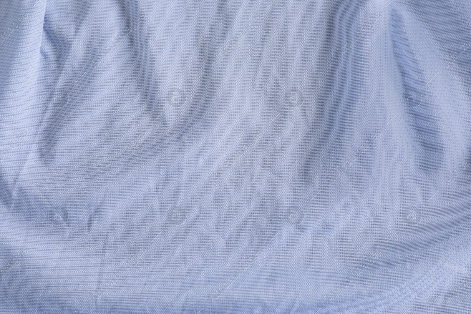 Photo of Crumpled light blue fabric as background, top view