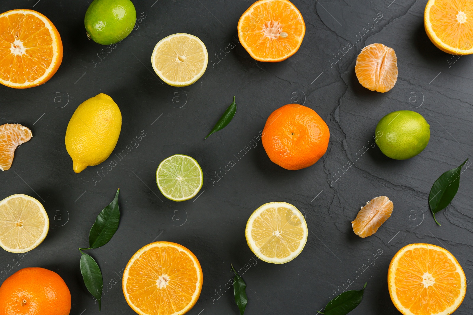 Photo of Flat lay composition with tangerines and different citrus fruits on black background