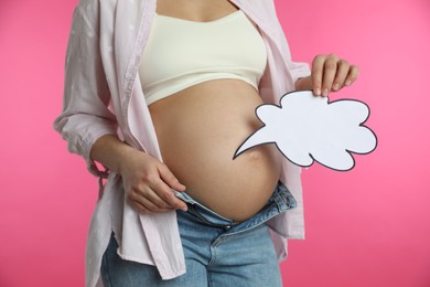 Photo of Pregnant woman with empty paper thought cloud on pink background, closeup. Choosing baby name