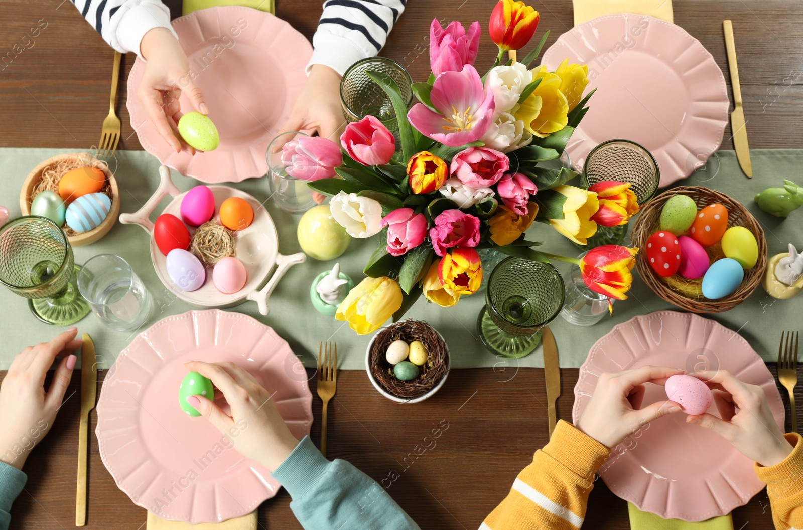 Photo of Festive table setting. Women celebrating Easter at home, top view