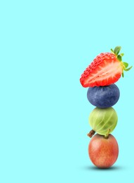Image of Stack of different fresh tasty berries on cyan background, space for text