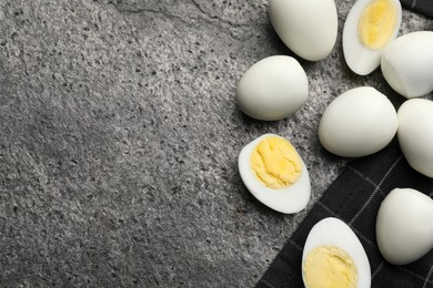 Photo of Peeled hard boiled quail eggs on grey table, flat lay. Space for text