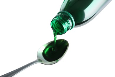 Pouring cough syrup into spoon on white background, above view