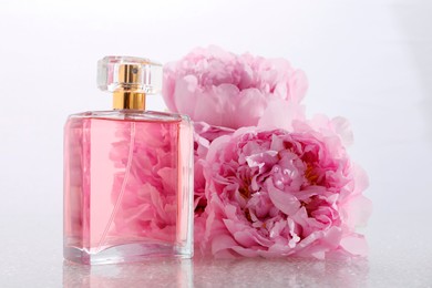 Luxury perfume and floral decor on plastic surface