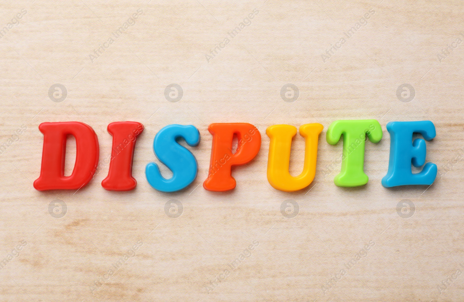 Photo of Word Dispute made of colorful letters on light wooden table, flat lay