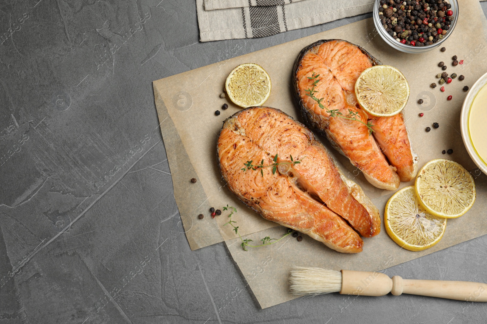 Photo of Delicious roasted fish on grey table, flat lay. Space for text