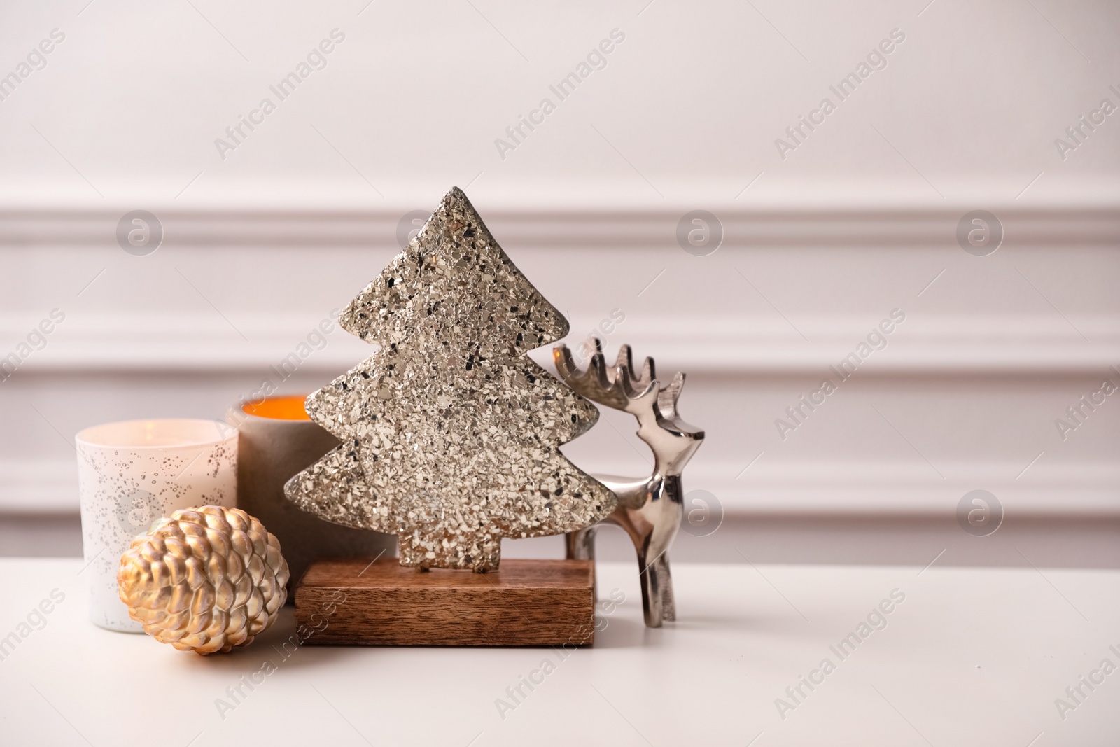 Photo of Composition with decorative Christmas tree and reindeer on light table
