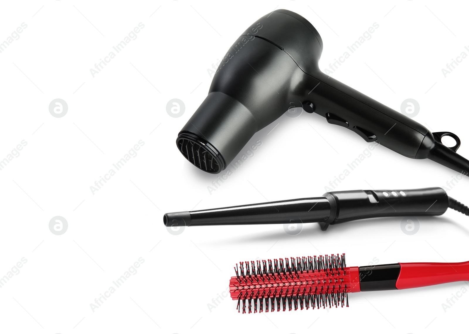 Image of Hair dryer, curling iron and brush on white background