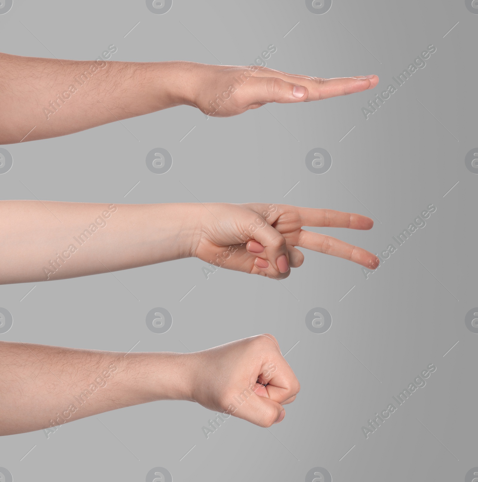 Image of People playing rock, paper and scissors on grey background, closeup