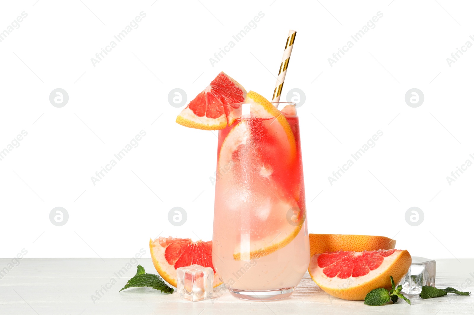 Photo of Glass of grapefruit refreshing drink with ice cubes and straw on wooden table against white background