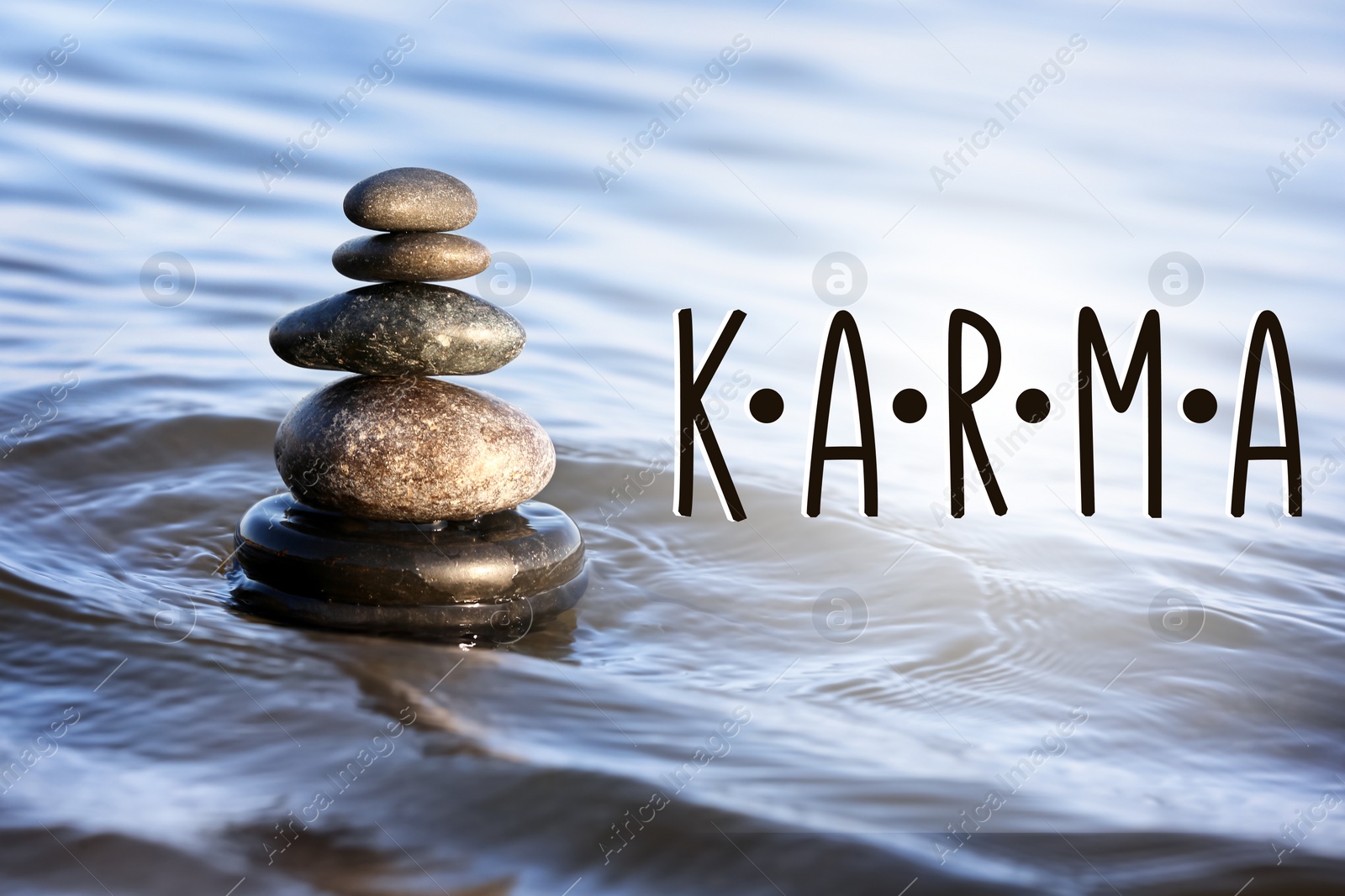 Image of Karma concept. Stack of stones in sea water