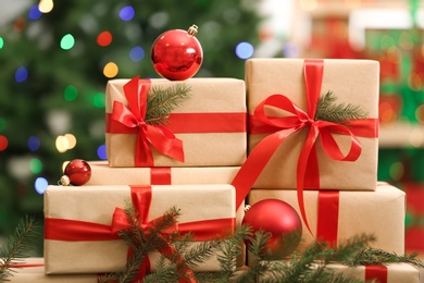 Photo of Many Christmas gifts on table against blurred background