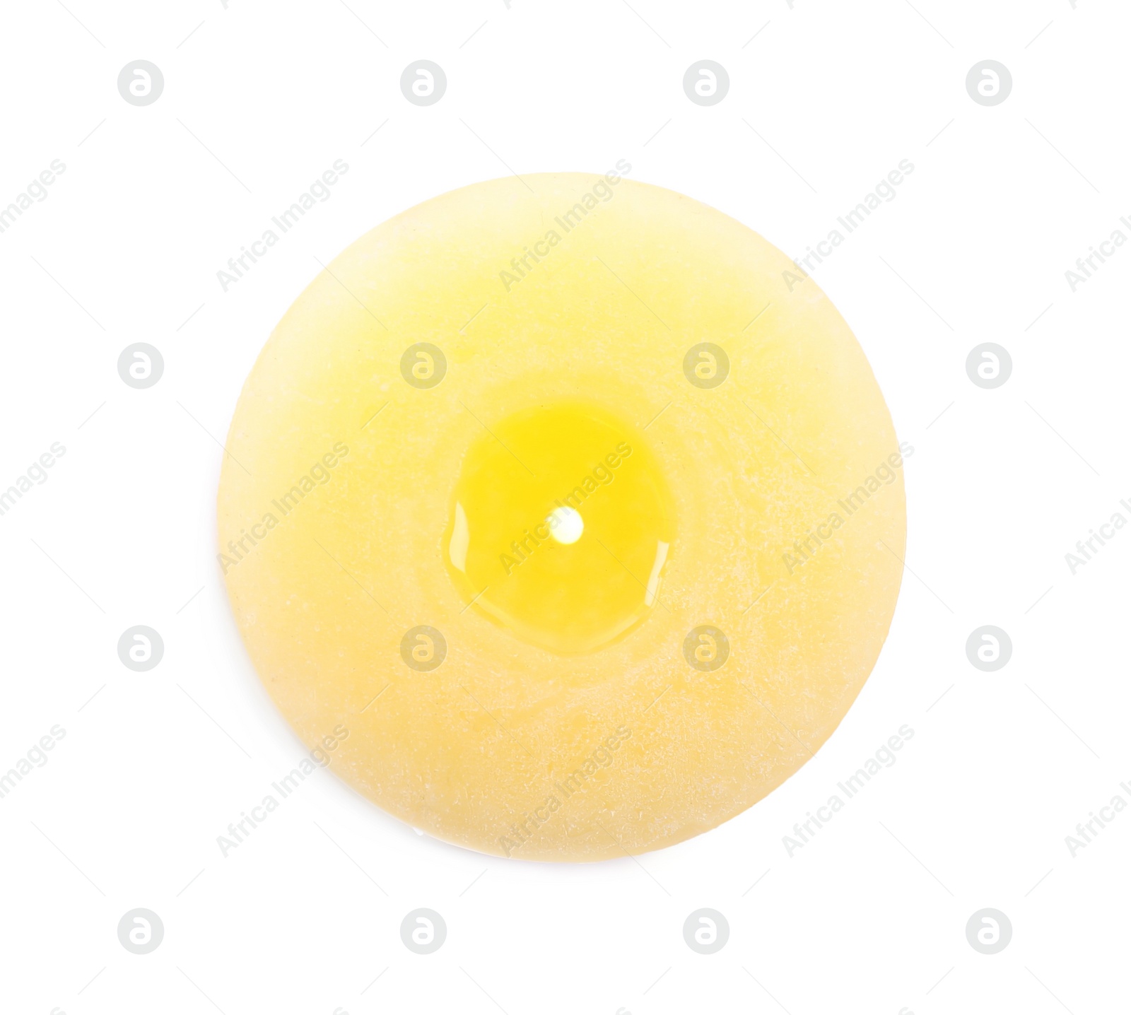 Photo of Burning yellow wax candle isolated on white, top view