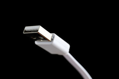 Photo of USB charge cable on black background, closeup. Space for text